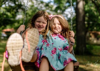 two sisters sharing a swing